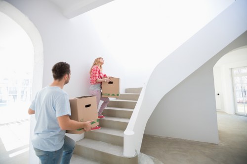 Commercial removals crew handling desks and boxes in SE16