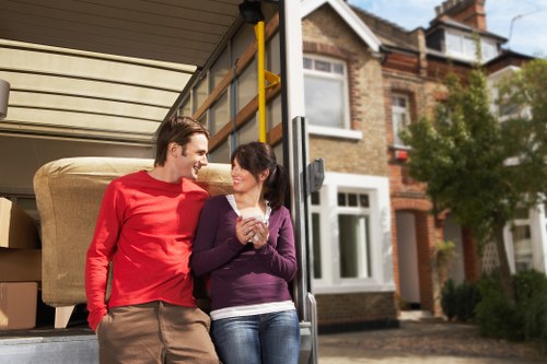 Specialist movers protecting a piano during transport in a South East London property
